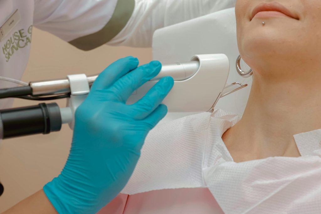 Close-up of a woman receiving a laser skin treatment in a clinic.